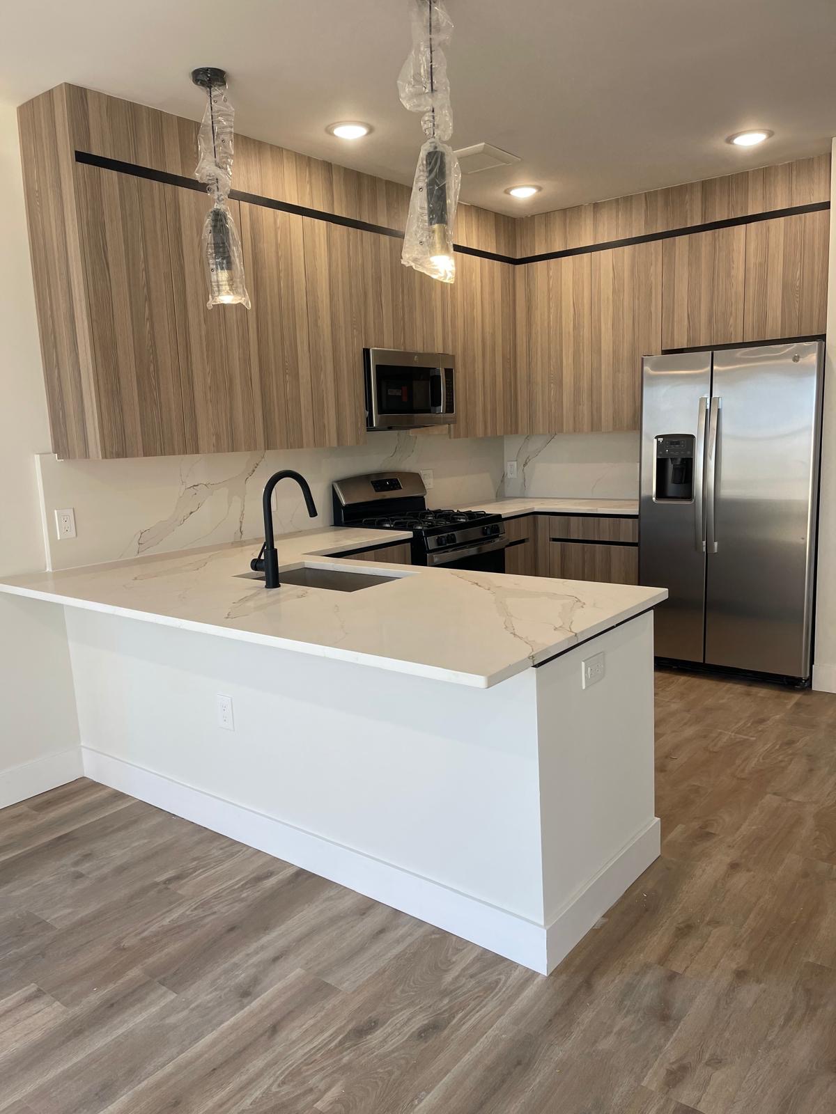 Commercial apartment kitchen cabinetry and quartz